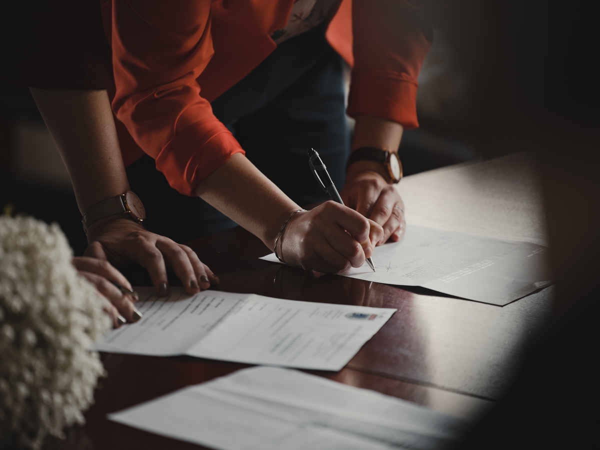 A woman signing documents